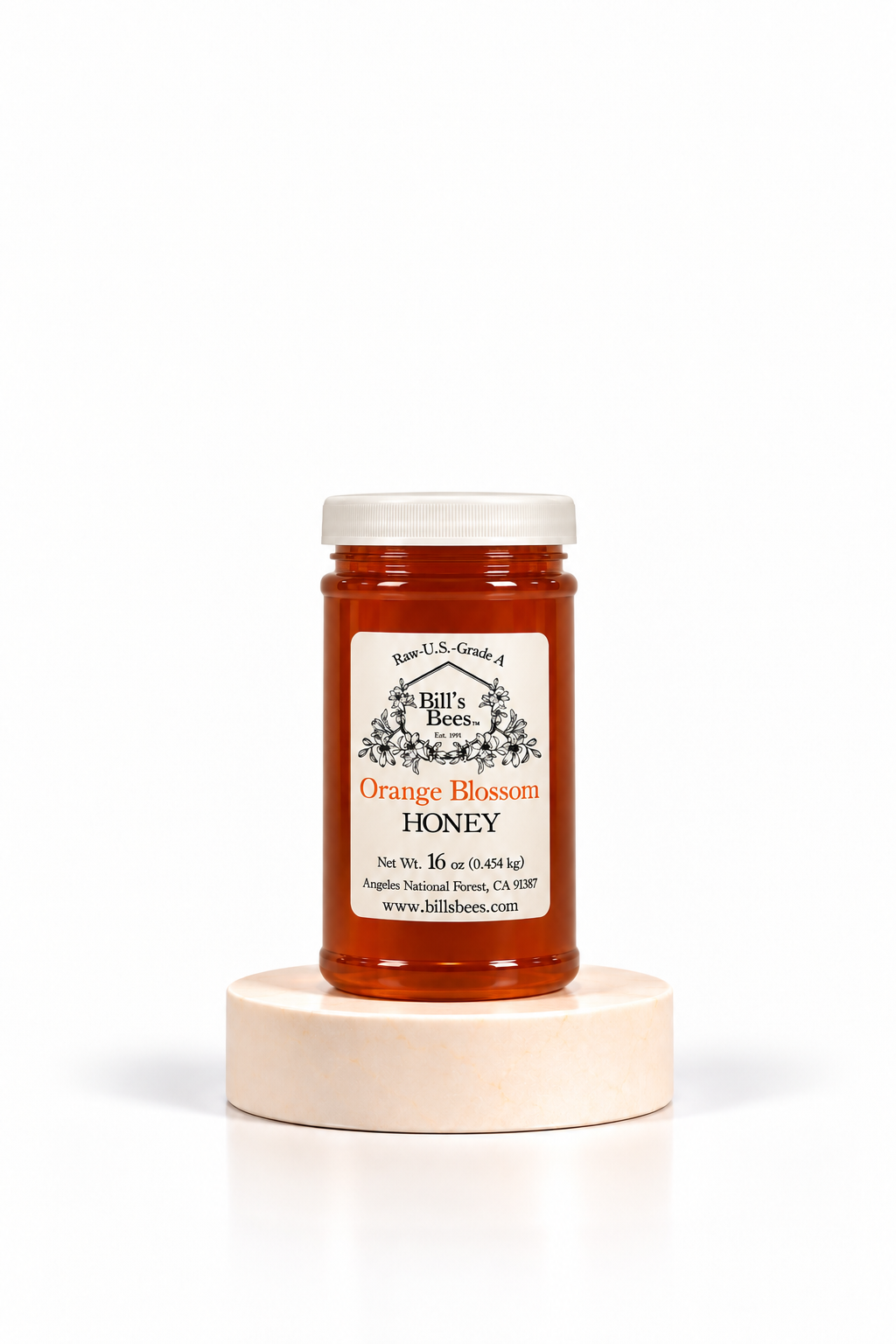 16 oz Bill's Bees Orange Blossom Honey jar on a stone pedestal, portrait format