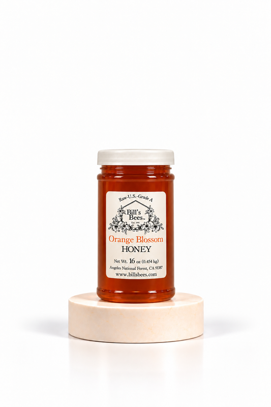 16 oz Bill's Bees Orange Blossom Honey jar on a stone pedestal, portrait format