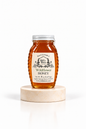 8 oz Bill's Bees Wildflower Honey jar on a marble pedestal, portrait format
