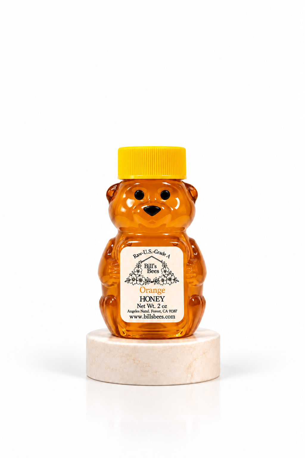 2 oz Bill's Bees Orange Blossom Honey squeeze bear on a marble pedestal, portrait format