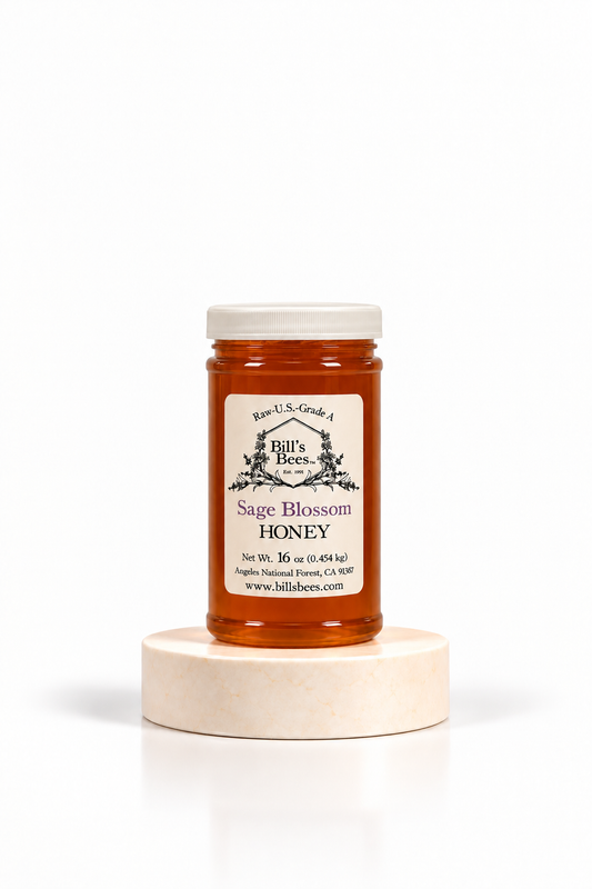 16 oz Bill's Bees Sage Blossom Honey jar on a marble pedestal, portrait format