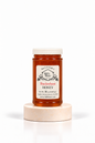 16 oz Bill's Bees Buckwheat Honey jar on a marble pedestal, portrait format