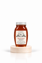8 oz Bill's Bees Buckwheat Honey jar on a marble pedestal, portrait format