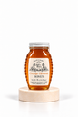 8 oz Bill's Bees Orange Blossom Honey jar on a marble pedestal, portrait format